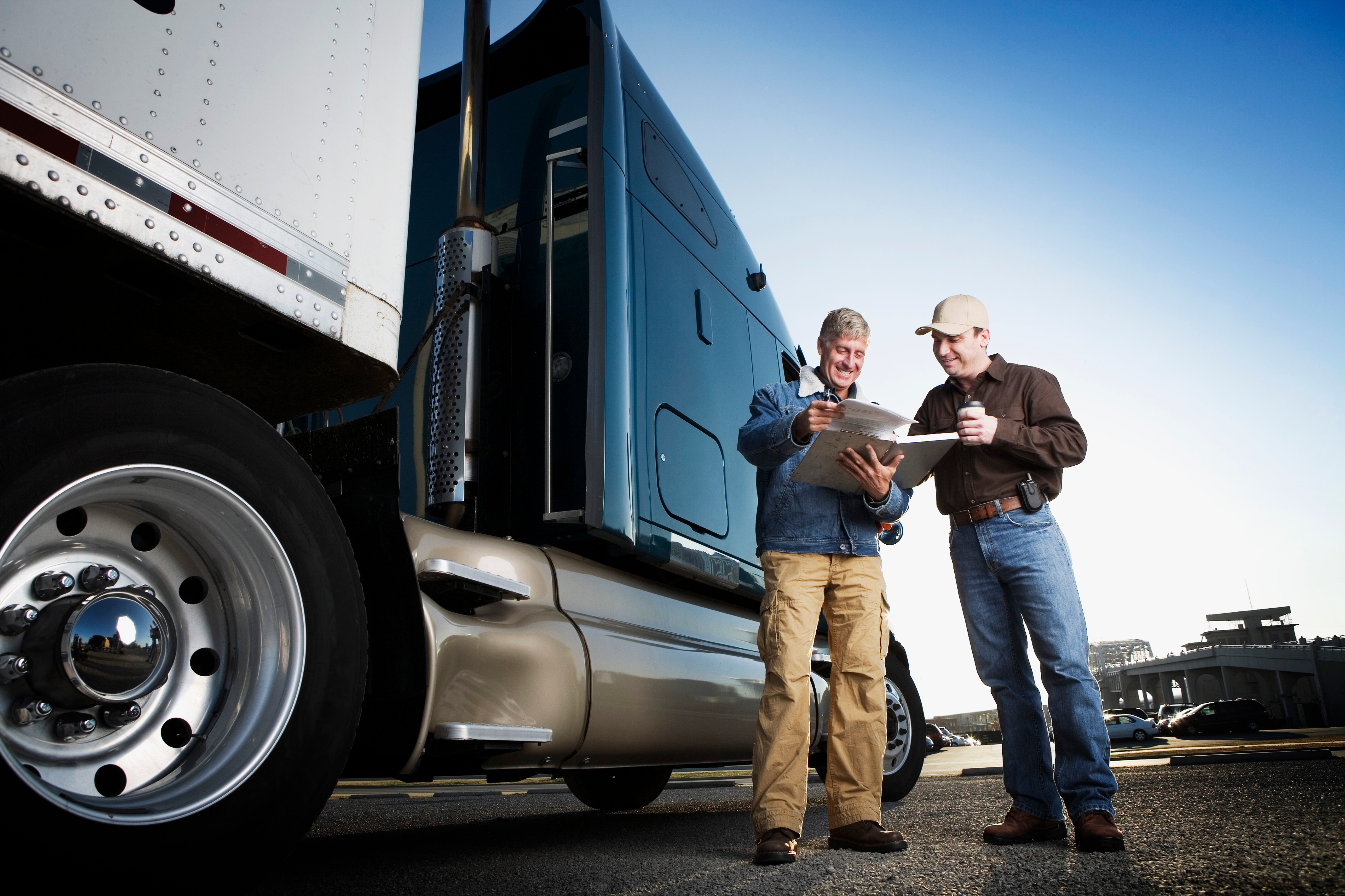 Truck driver meets with a fleet manager over a pre-trip inspection