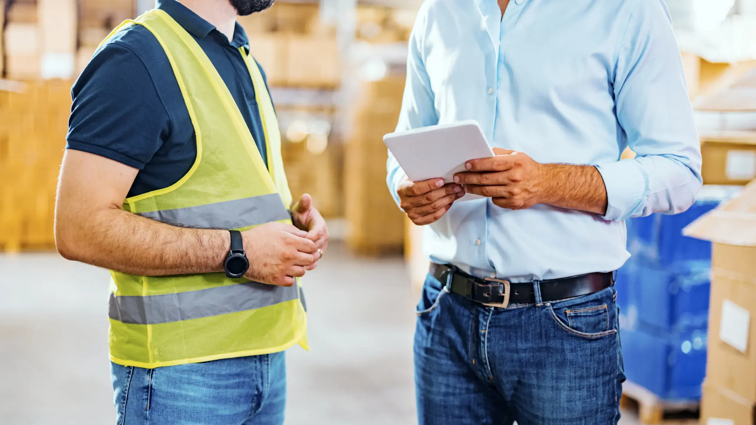 Shot of a manager holding a digital tablet and talking to a truck driver